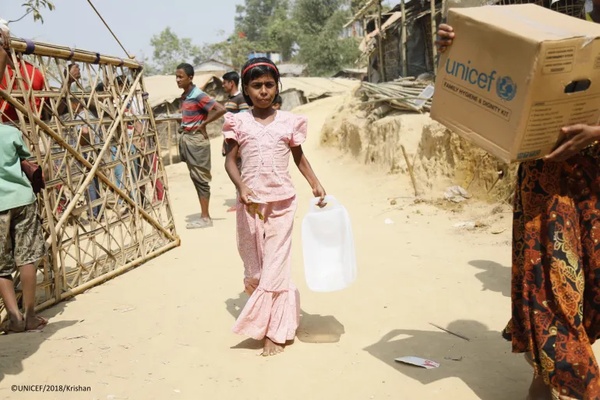 water collection in humanitarian aid context family collecting water in humanitarian setting